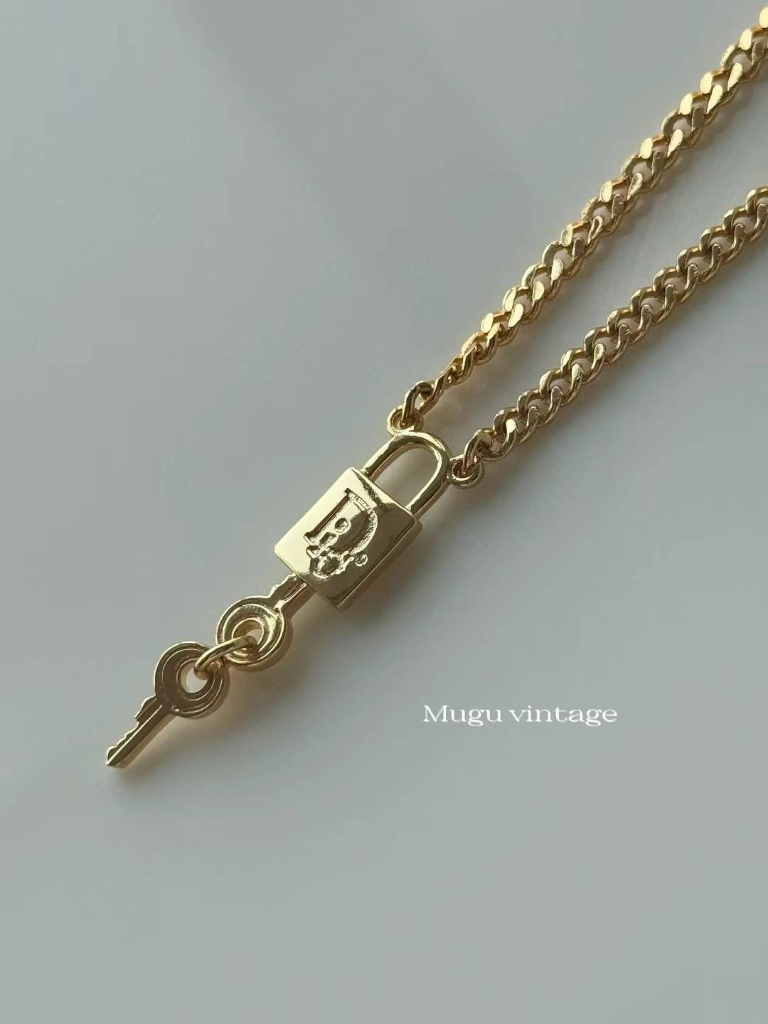Christian Dior gold lock unisex necklace